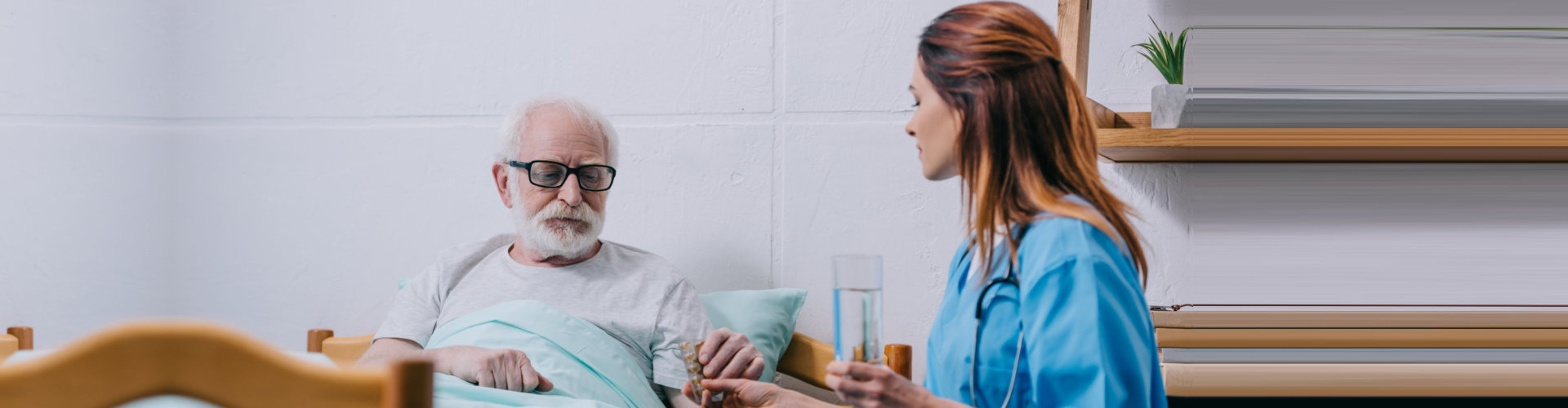 caregiver giving her patient a medicine